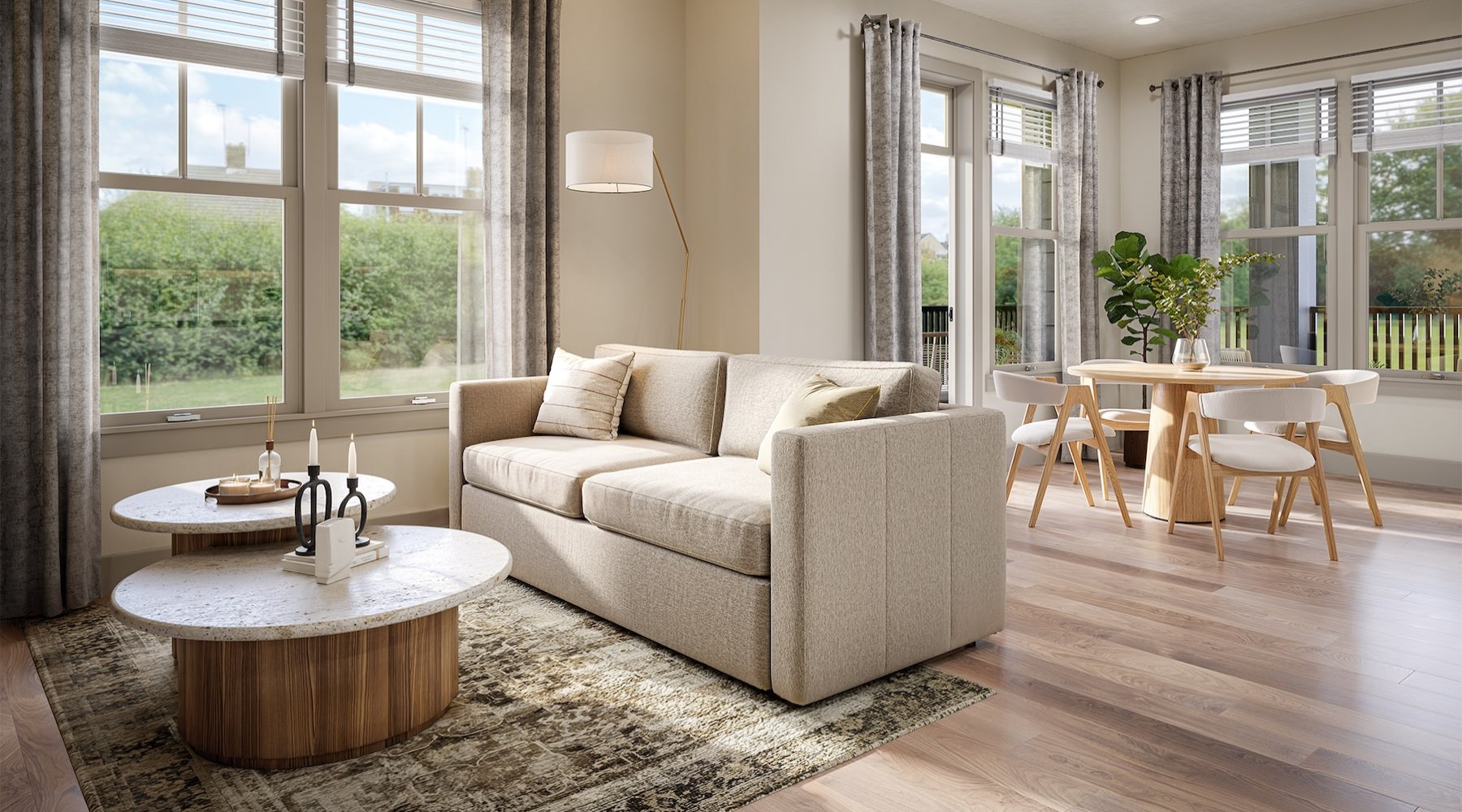 a living room with a couch, coffee table and dining room